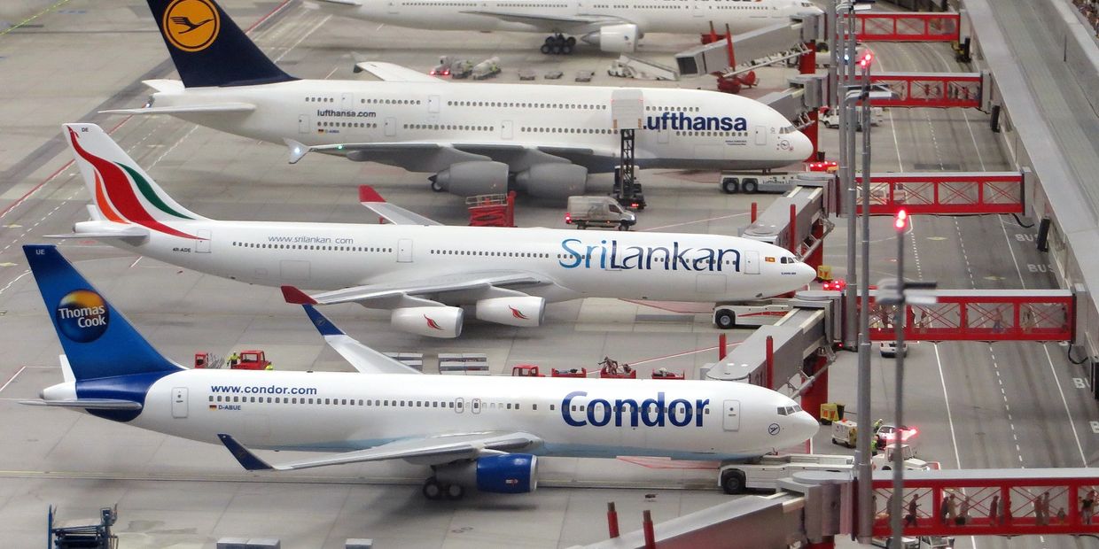 Three aircrafts parked at an airport