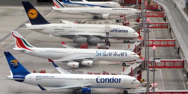 five aircrafts parked at an airport
