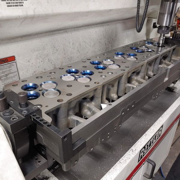 Engine cylinder head being machined on a Rottler seat and guide machine.