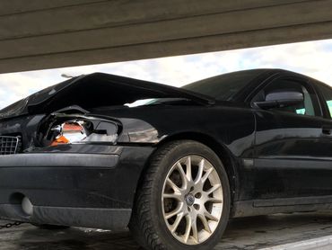 Scrap car towing in action – removing an old car from a parking lot