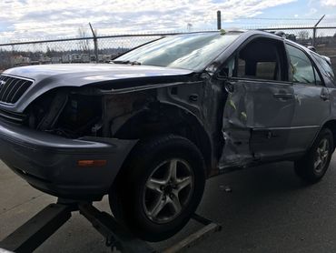 Driver towing a junk SUV for scrap car removal