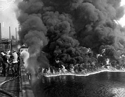 A fire tug fights flames on the Cuyahoga River near downtown Cleveland on June 25, 1952 (Time 2015).