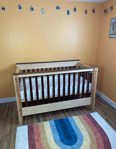 Maple and Walnut baby crib in nursery.