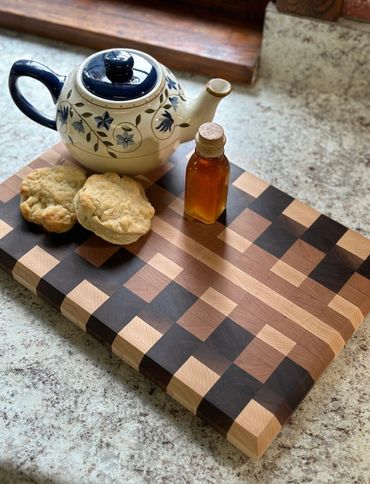 End Grain patterned cutting board with tea and biscuits.