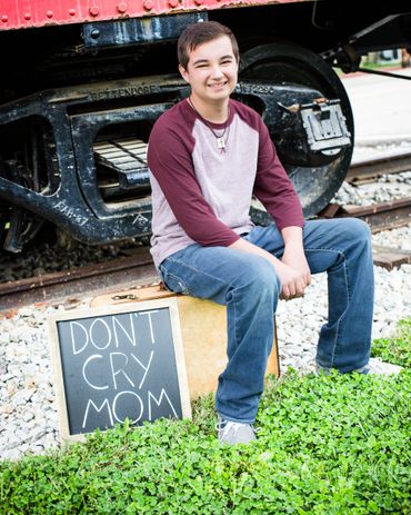 Senior photography of boy at train station