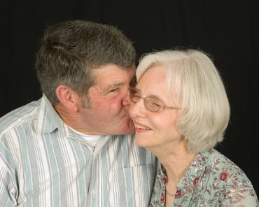 Couples photography of husband kissing wife