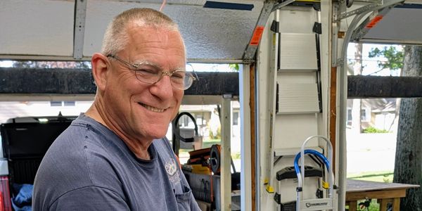 Smiling man in cabinet shop