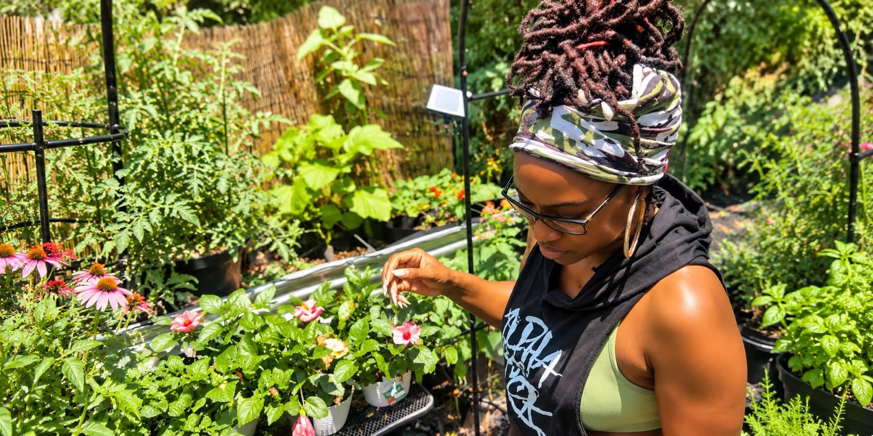 Herbal Rootz founder tending plants and flowers in her home garden.