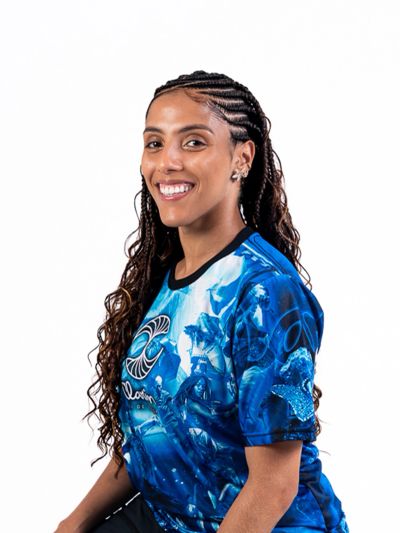 Smiling woman with braided hair wearing a blue graphic t-shirt.