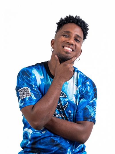 Smiling man in a vibrant blue graphic t-shirt poses with hand on chin.