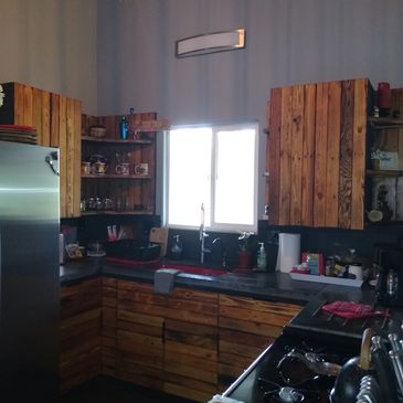 Volcano themed kitchen with custom upcycled fire treated cabinets and concrete countertops