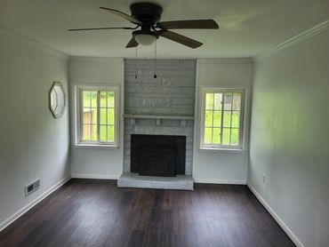 The family room has a fireplace and lots of natural light