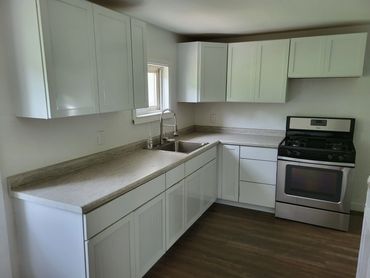 The kitchen has all new cabinetry, counter tops, wiring and flooring