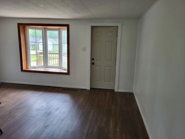 Living room with bay window and southern exposure perfect for the plant lover