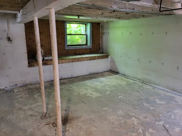 Unfinished basement with day light window and bathroom rough in
