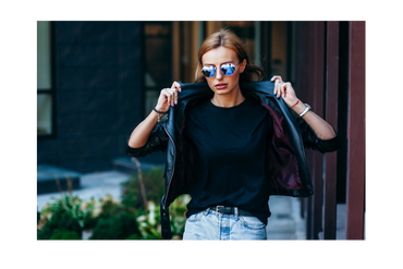 Woman wearing sunglasses and a leather jacket outdoors.