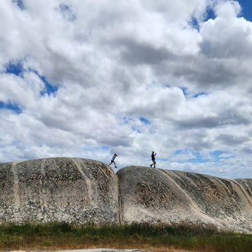 A picture of the kids running on the hill