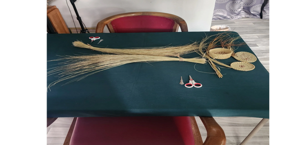 Materials and tools laid out for sweetgrass basket weaving class.