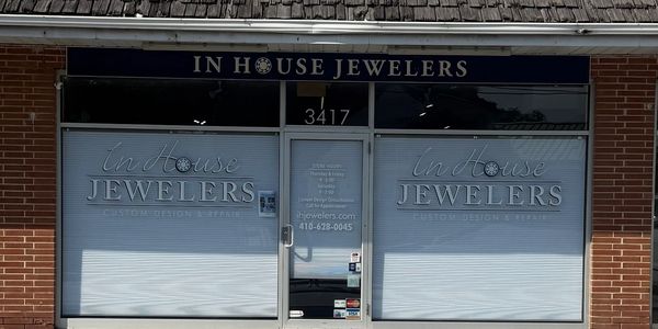 Storefront of In House Jewelers with contact details.