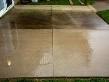 Concrete patio showing before and after cleaning comparison.
