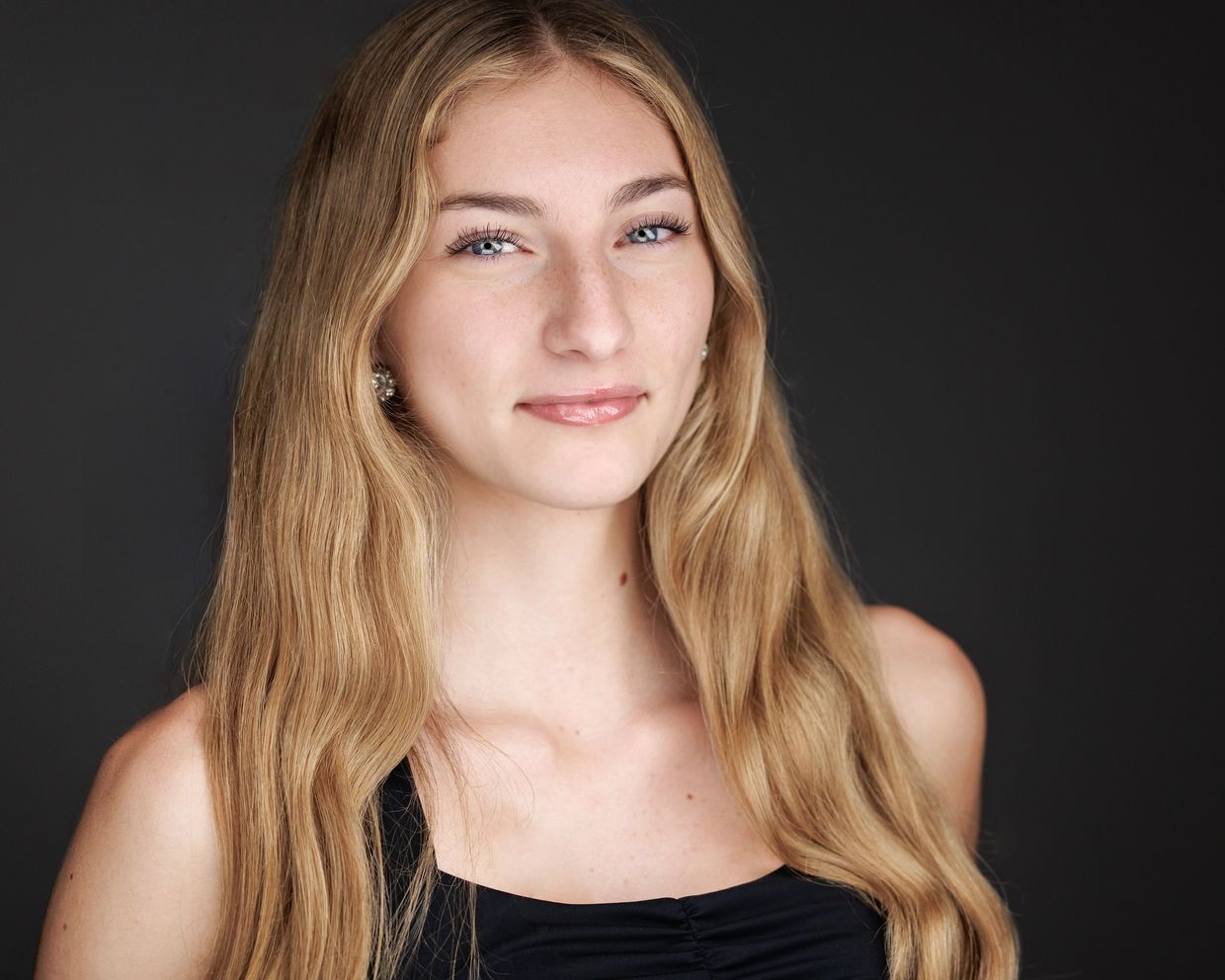 Young woman with long blonde hair and blue eyes.