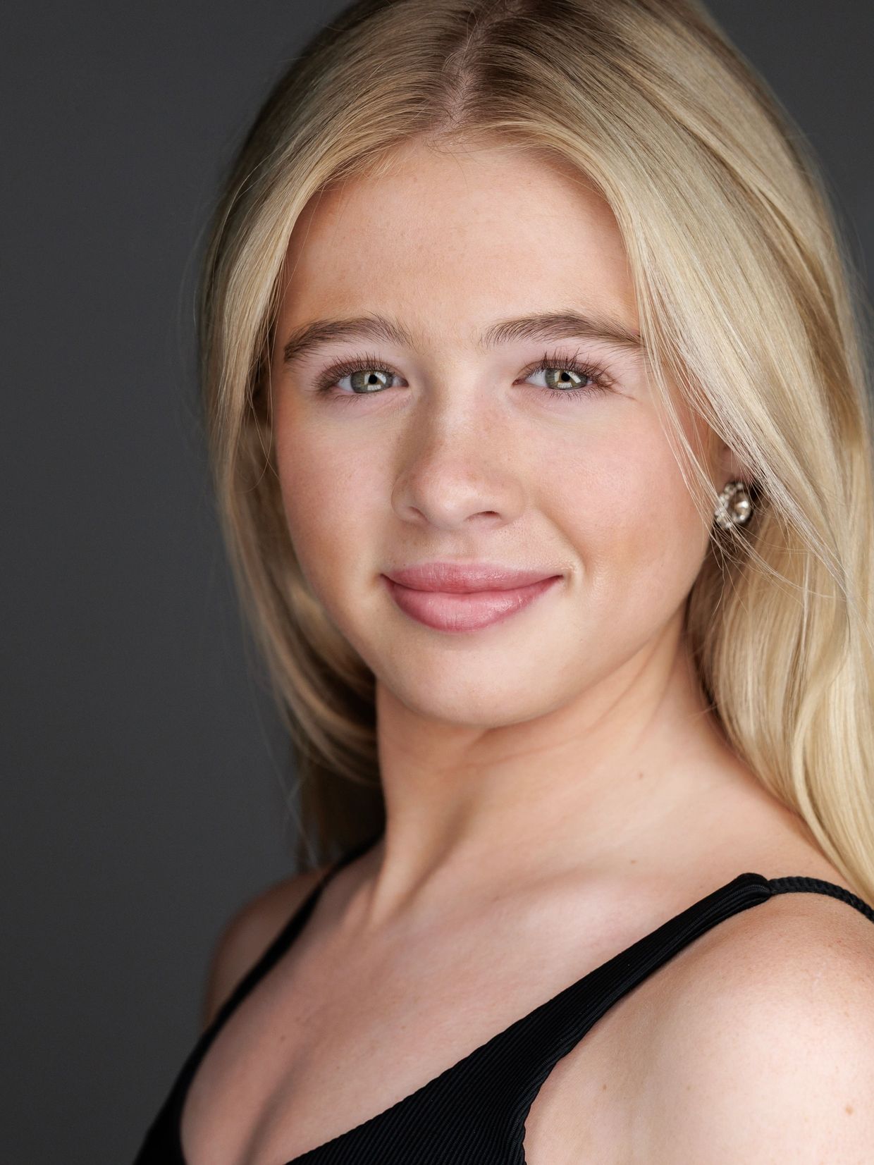 Portrait of a smiling young woman with blonde hair.