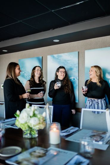 Four team members enjoying a beverage and talking about the plans for the upcoming wedding season.