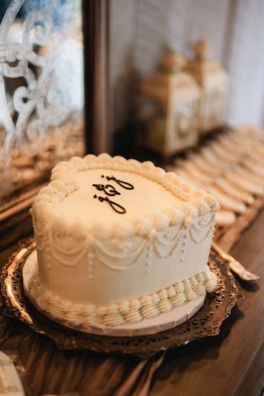 Vintage white wedding cake in the shape of a heart.