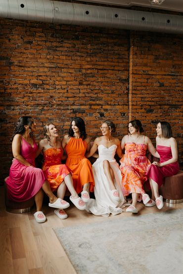 Bride with bridal party in pinks and oranges.