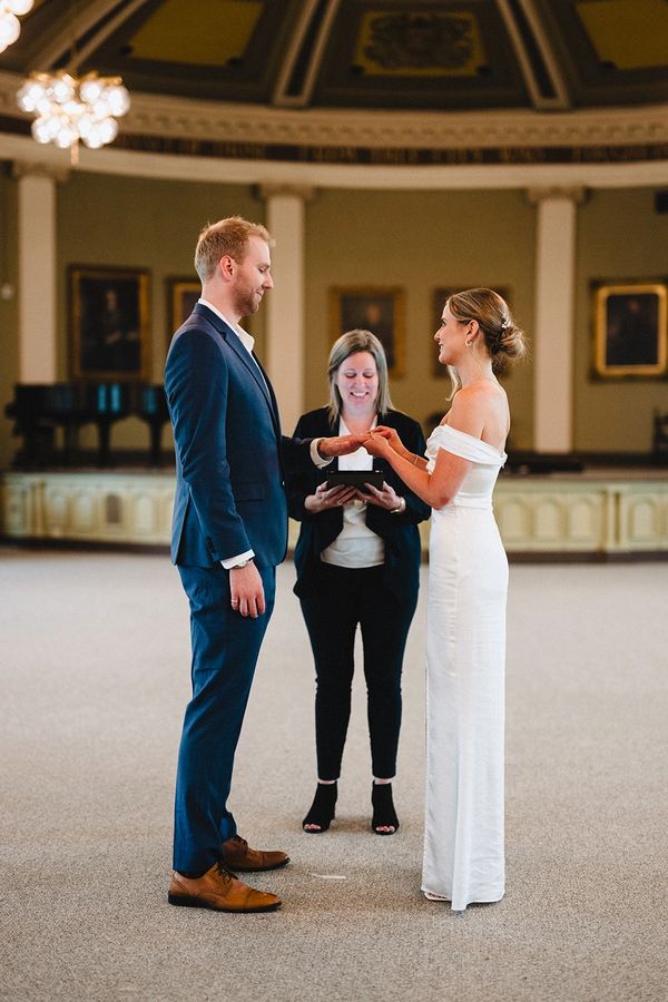 Elopement at City Hall in Kingston. Groom in a blue suit, bride in a floor length gown.