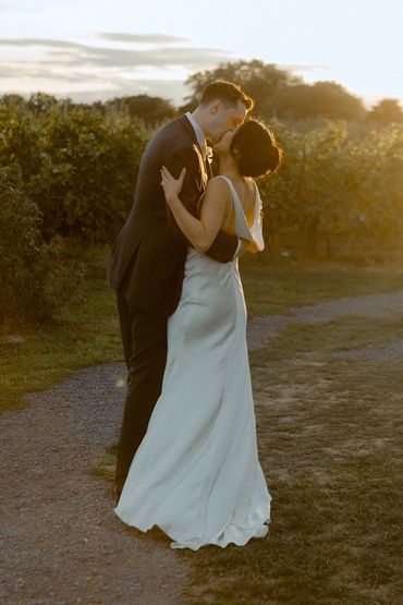 Bride and groom doing sunset photos in a vineyard.