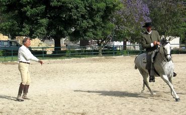 John Saint Ryan receiving instruction on Doma Vaquera riding techniques.