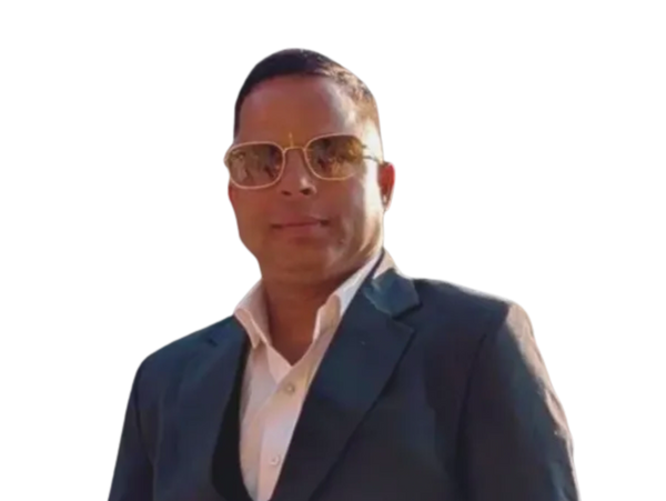 Man in a suit wearing sunglasses, looking confident.