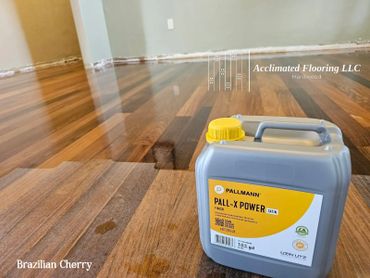 A can of Pall-X Power finish on freshly coated Brazilian Cherry hardwood floor.