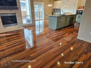Shiny Brazilian Cherry hardwood flooring in a modern kitchen and living area.