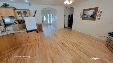 Bright maple hardwood flooring in a cozy home interior.