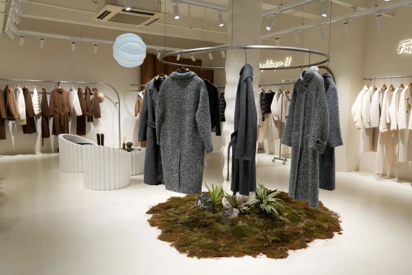 Modern clothing store with stylish coats on display.