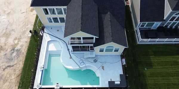 Aerial view of a house with a swimming pool.