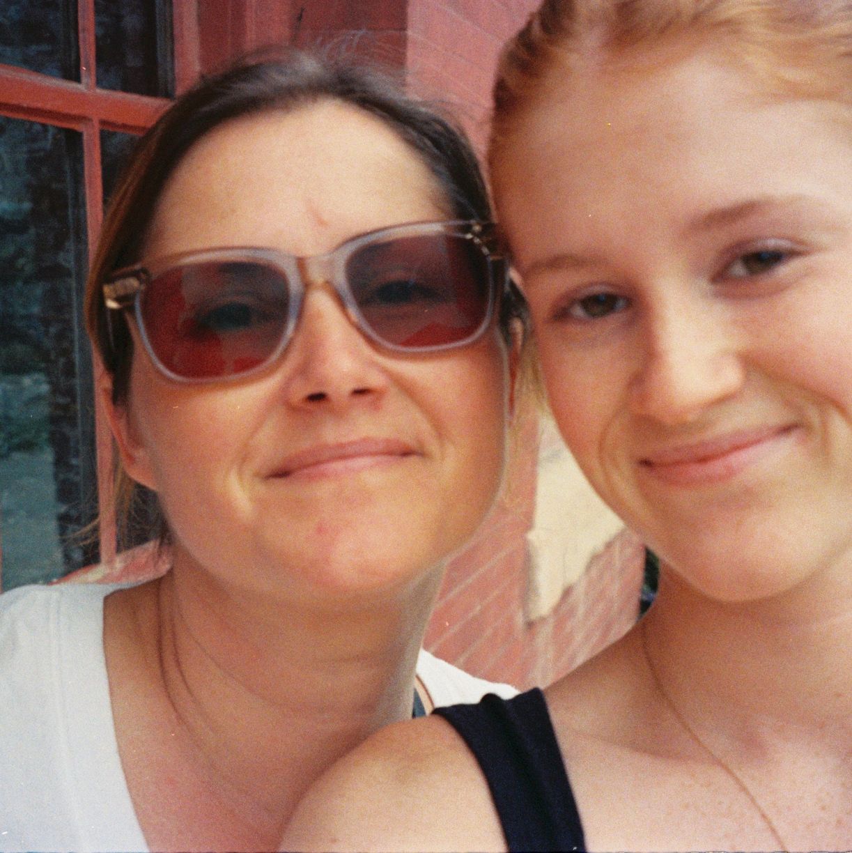 Two women smiling for a close-up selfie.