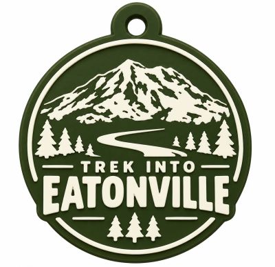 Circular tag with mountain and trees, 'Trek Into Eatonville' text.