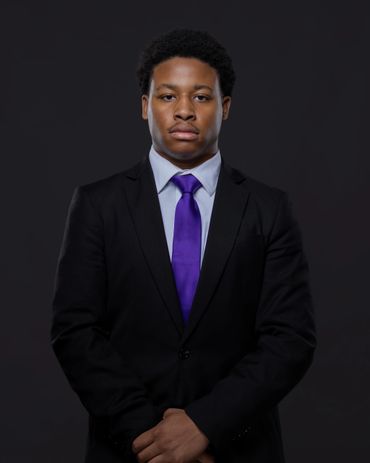 Professional corporate headshot for young male professional in dark studio — RedHed Photography, Tal