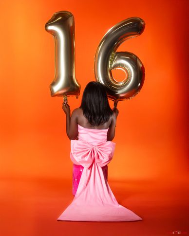 Sweet 16 milestone portrait with gold balloons and pink gown on orange backdrop — luxury portrait ph