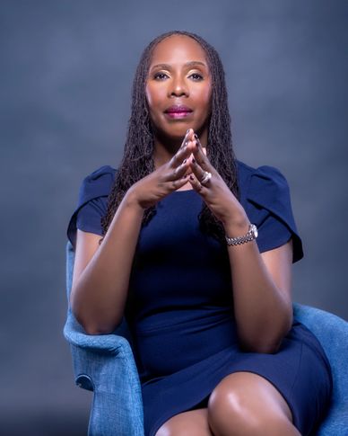 Executive branding portrait with power pose in blue studio setting — personal branding photography b