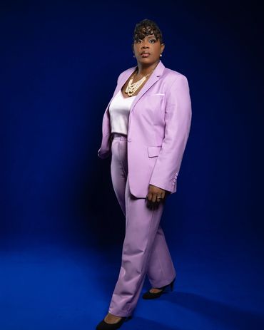 Full-length branding headshot with royal blue studio backdrop and lavender suit — RedHed Photography