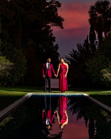Luxury outdoor couples lifestyle portrait with pool reflection and dramatic sunset sky — on-location