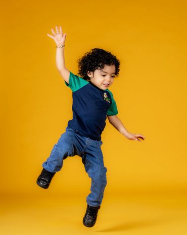Commercial action portrait of child jumping in branded academy uniform — brand campaign by RedHed, T