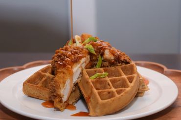 Commercial food photography of chicken and waffles with sauce drizzle RedHed, Chicago IL
