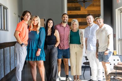 Candid group portrait at private indoor event with natural mixed lighting event photography by RedHe