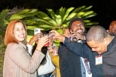 Candid group celebration moment with guests raising glasses in a toast event photography by RedHed P