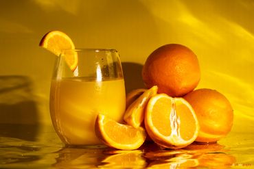 Commercial beverage product photography with styled orange juice RedHed Tallahassee FL